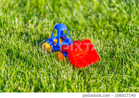 plastic toy car on a green grass 106027140
