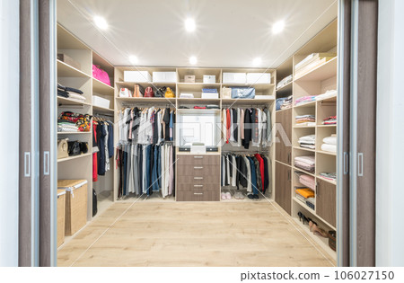 Big wardrobe with different clothes for dressing room Big wardrobe with different clothes for dressing room 106027150