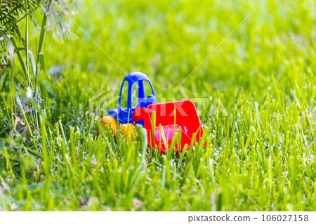 plastic toy car on a green grass 106027158
