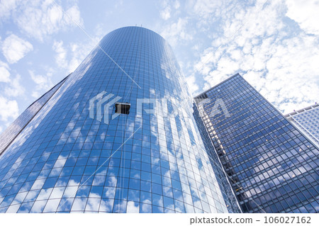 Two cleaners washing the windows of modern skyscraper Two cleaners washing the windows of modern skyscraper 106027162