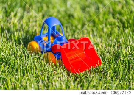 plastic toy car on a green grass 106027170