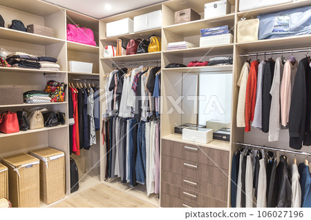 Big wardrobe with different clothes for dressing room Big wardrobe with different clothes for dressing room 106027196