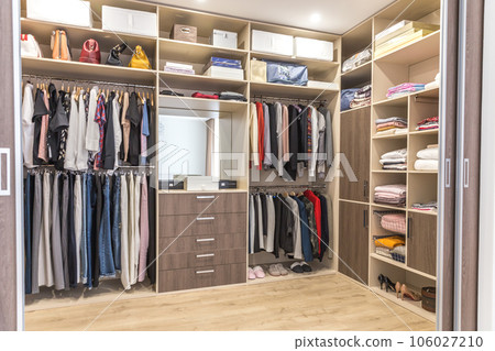 Big wardrobe with different clothes for dressing room 106027210