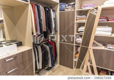 Big wardrobe with different clothes for dressing room Big wardrobe with different clothes for dressing room 106027260