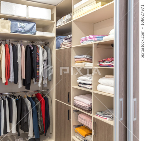 Big wardrobe with different clothes for dressing room Big wardrobe with different clothes for dressing room 106027971