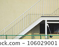background of metal stairs on yellow exterior wall 106029001