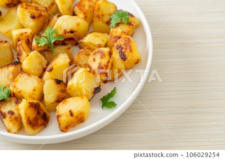 Roasted or grilled potatoes  on plate 106029254