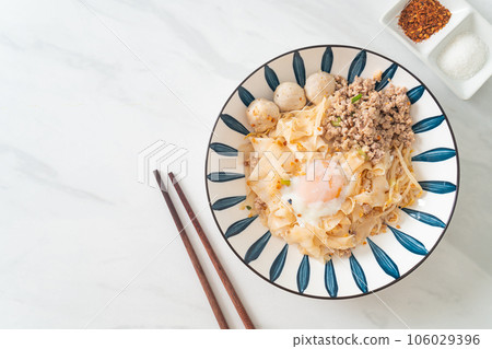 dried spicy noodles with minced pork, meatballs and egg 106029396