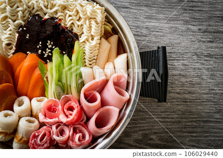 Budae Jjigae or Budaejjigae (Army stew or Army base stew). It is loaded with Kimchi, spam, sausages, ramen noodles and much more 106029440