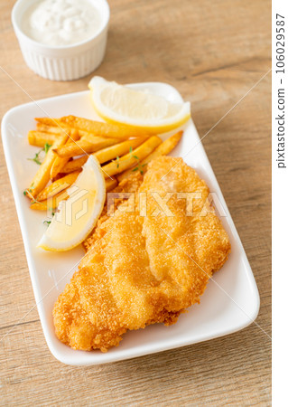 fish and chips - fried fish fillet with potatoes chips fish and chips - fried fish fillet with potatoes chips 106029587
