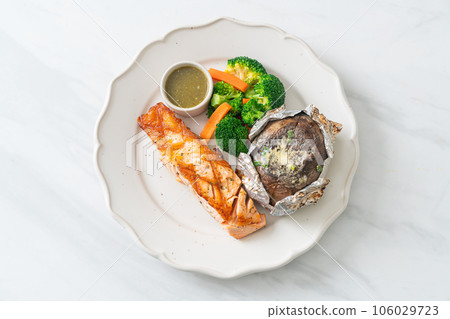 grilled salmon steak with bake potato grilled salmon steak with bake potato 106029723