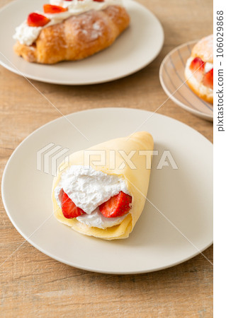 fresh strawberry cream crepe on plate fresh strawberry cream crepe on plate 106029868