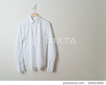 hanging shirt with wood hanger on wall 106029988
