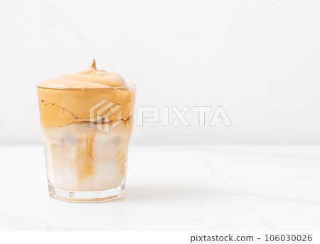Iced Dalgona Coffee, a trendy fluffy creamy whipped coffee 106030026