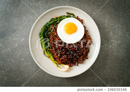 dried Korean spicy black sauce instant noodles with fried egg and kimchi 106030166