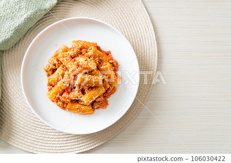 Rigatoni pasta bolognese with cheese Rigatoni pasta bolognese with cheese 106030422