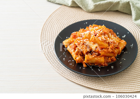 Rigatoni pasta bolognese with cheese 106030424