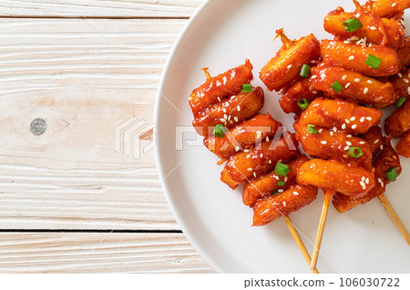 deep fried Korean rice cake (Tteokbokki) skewered with spicy sauce deep fried Korean rice cake (Tteokbokki) skewered with spicy sauce 106030722