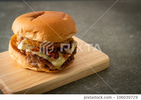 pork burger with cheese, bacon and onion rings 106030729