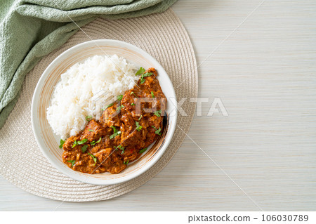 chicken tikka masala with rice on plate 106030789