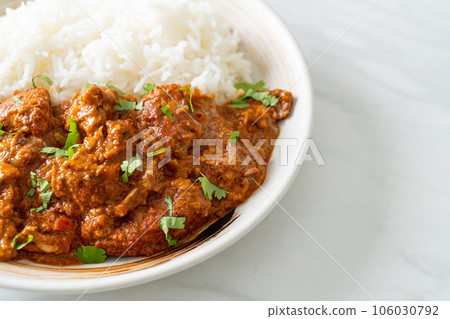 chicken tikka masala with rice on plate 106030792