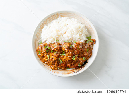 chicken tikka masala with rice on plate 106030794