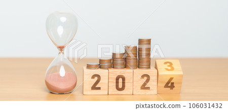 Happy New Year with sandglass and flipping 2023 change to 2024 block. Resolution, Goals, Plan, Action, Money Saving, Retirement fund, Pension, Investment and Financial concept 106031432