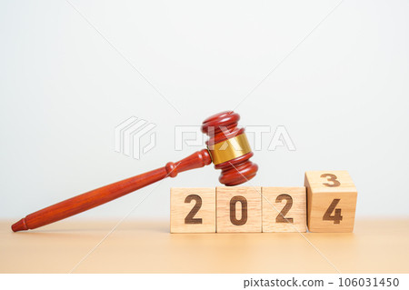 2023 chcnge to 2024 year block with judge gavel on table. Law, lawyer, judgment, justice auction and bidding concept 106031450