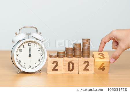 Happy New Year with vintage alarm clock and flipping 2023 change to 2024 block. Resolution, Goals, Plan, Action, Money Saving, Retirement fund, Pension, Investment and Financial concept 106031758