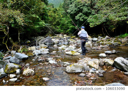 An angler fishing in the mountain stream near Hiraname Falls on the Kawazu River 106033090