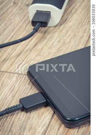 External powerbank using to charge empty battery of black smartphone External powerbank using to charge empty battery of black smartphone 106033830