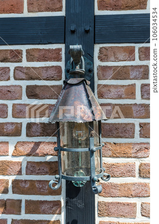 Vintage street lamp on brick wall 106034534