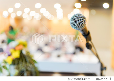 Wired microphone set up on the front of conference room close up with blurred background.  Wired microphone close up with copy space background. 106036301