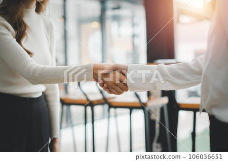 Business partnership meeting concept. Image business womans handshake. Successful businessmen handshaking after good deal.. 106036651