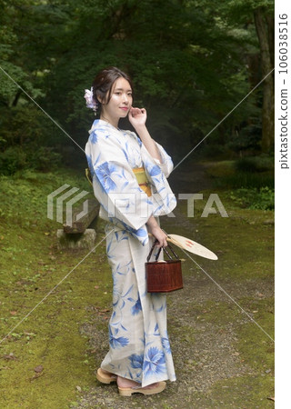 A portrait of a young woman in a beautiful yukata against the backdrop of an early summer forest A portrait of a young woman in a beautiful yukata against the backdrop of an early summer forest 106038516