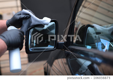 Car detailing. Side view mirrors of car are wiped with napkin.Concept of purity. 106038873