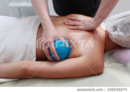 Body massage with silicone jars. Massage remedy for getting rid of cellulite.Vacuum massage. Body massage with silicone jars. Massage remedy for getting rid of cellulite.Vacuum massage. 106038874