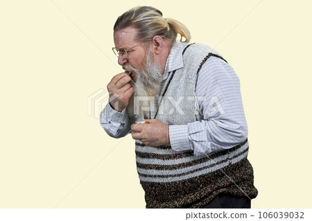 Senior bearded man taking medicine pill. Isolated on white background. Senior bearded man taking medicine pill. Isolated on white background. 106039032