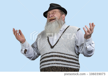 Portrait of senior man laughing out loud very hard. Isolated on blue background. 106039073