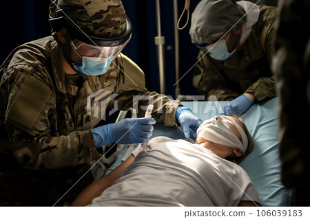 A military doctor provides first aid to a wounded patient 106039183