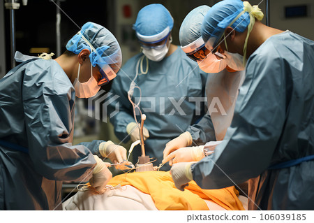 A group of surgeons performing an operation in a military hospital 106039185