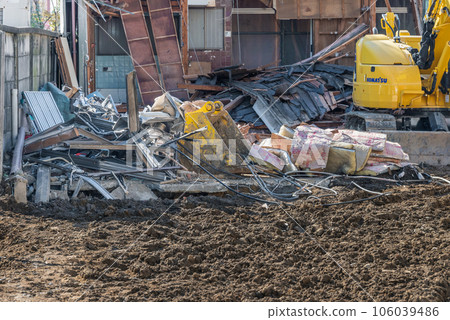 Demolition work on a vacant house: Waste wet with heavy machinery and water 106039486