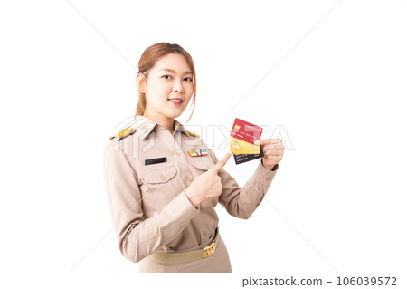 Female Thai government officer in khaki uniforms smiling and pointing on white background. Asian woman holding credit cards for transaction money. Concept of advertising, payment purchase, financial. Female Thai government officer in khaki uniforms smiling and pointing on white background. Asian woman holding credit cards for transaction money. Concept of advertising, payment purchase, financial. 106039572