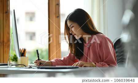 Beautiful charming businesswoman putting written signature on business document at office desk. Beautiful charming businesswoman putting written signature on business document at office desk. 106039648