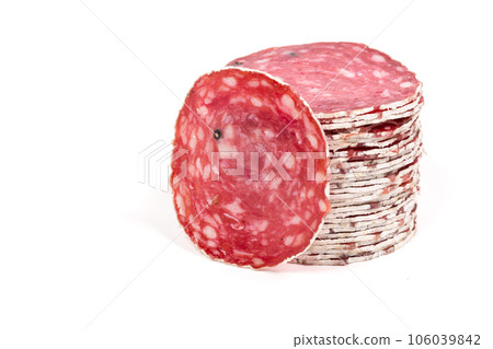 Slices of salami sausage on a white background Slices of salami sausage on a white background 106039842