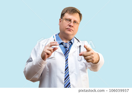 Doctor points his finger at the camera, the concept of health care, regular visits to doctor Doctor points his finger at the camera, the concept of health care, regular visits to doctor 106039937