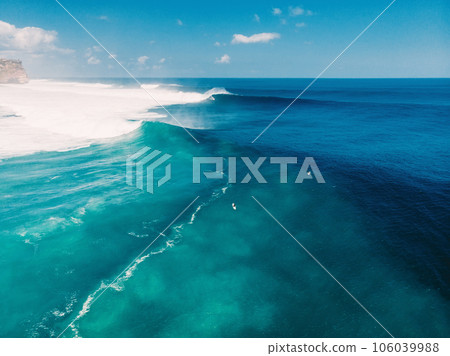 Aerial view of big blue waves and surfing in Bali. Uluwatu beach Aerial view of big blue waves and surfing in Bali. Uluwatu beach 106039988
