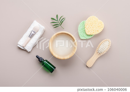 Homemade cosmetic rice water with beauty kit on beige background, top view copy space, home spa flat lay 106040006