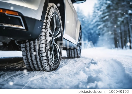 Winter tire. Car on snow road. Tires on snowy highway detail. 106040103
