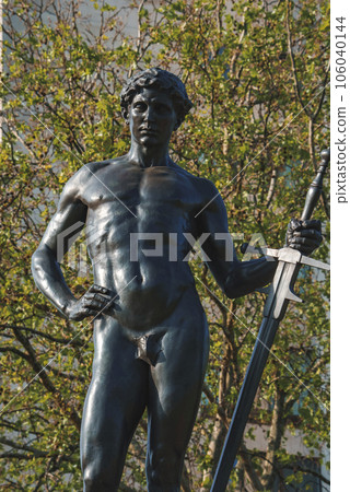 The Boy David Statue in front of trees. Machine Gun Corps memorial on sunny day. Famous landmark of London sculptured in bronze. 106040144